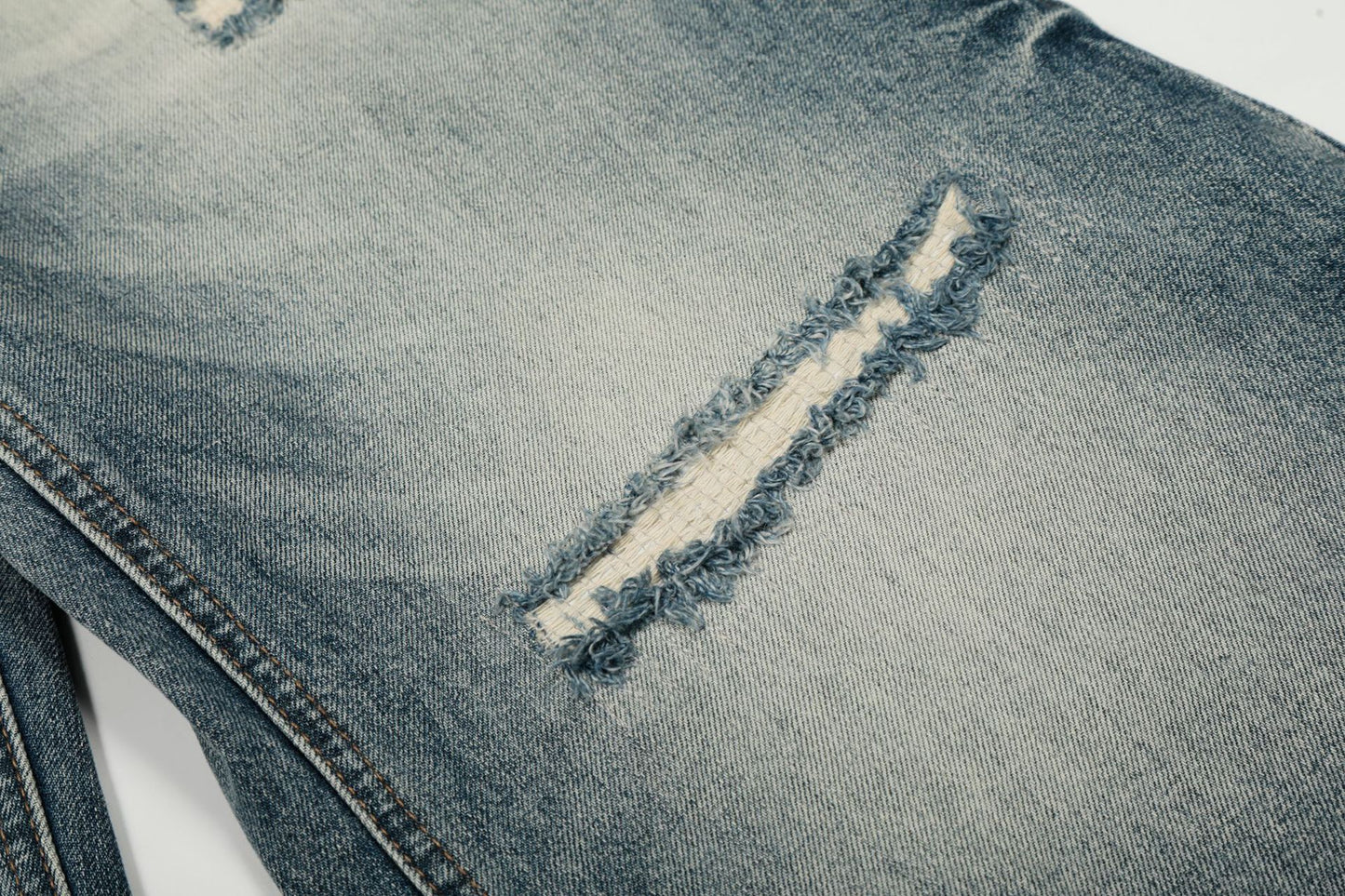 Washed Whisker Damage Curved Denim Jeans WN25863